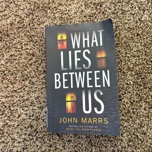 What Lies Between Us by John Marrs paperback thriller book